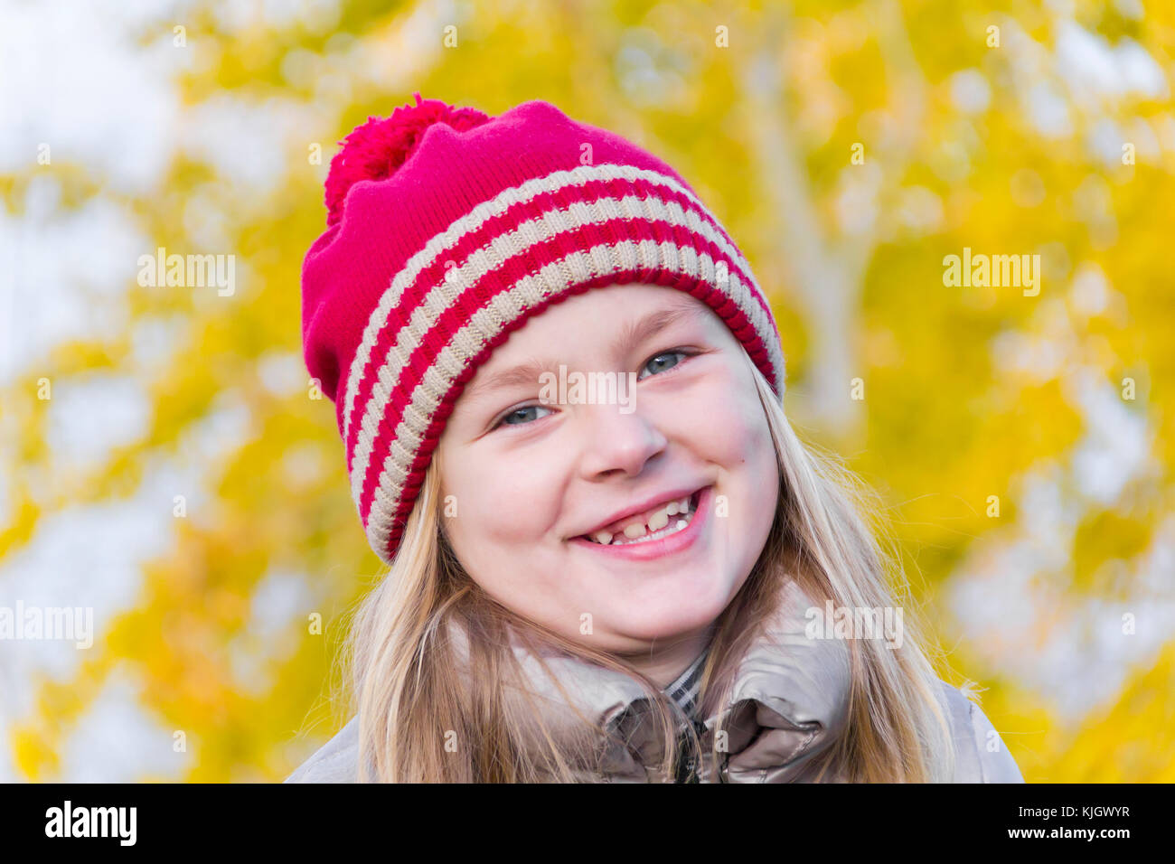 Portrait of cute smiling girl in red hat Stock Photo - Alamy