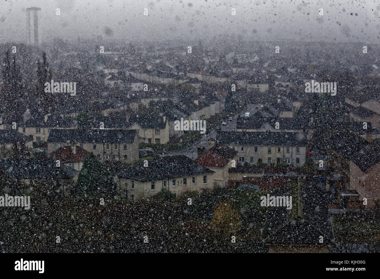 Glasgow, Scotland, UK  24th November. UK Weather: First snow to fall in the city as heavy showers hit the whole city the south of the city invisible behind knightswood with visibility reduced because of intensity. Credit Gerard Ferry/Alamy news Stock Photo