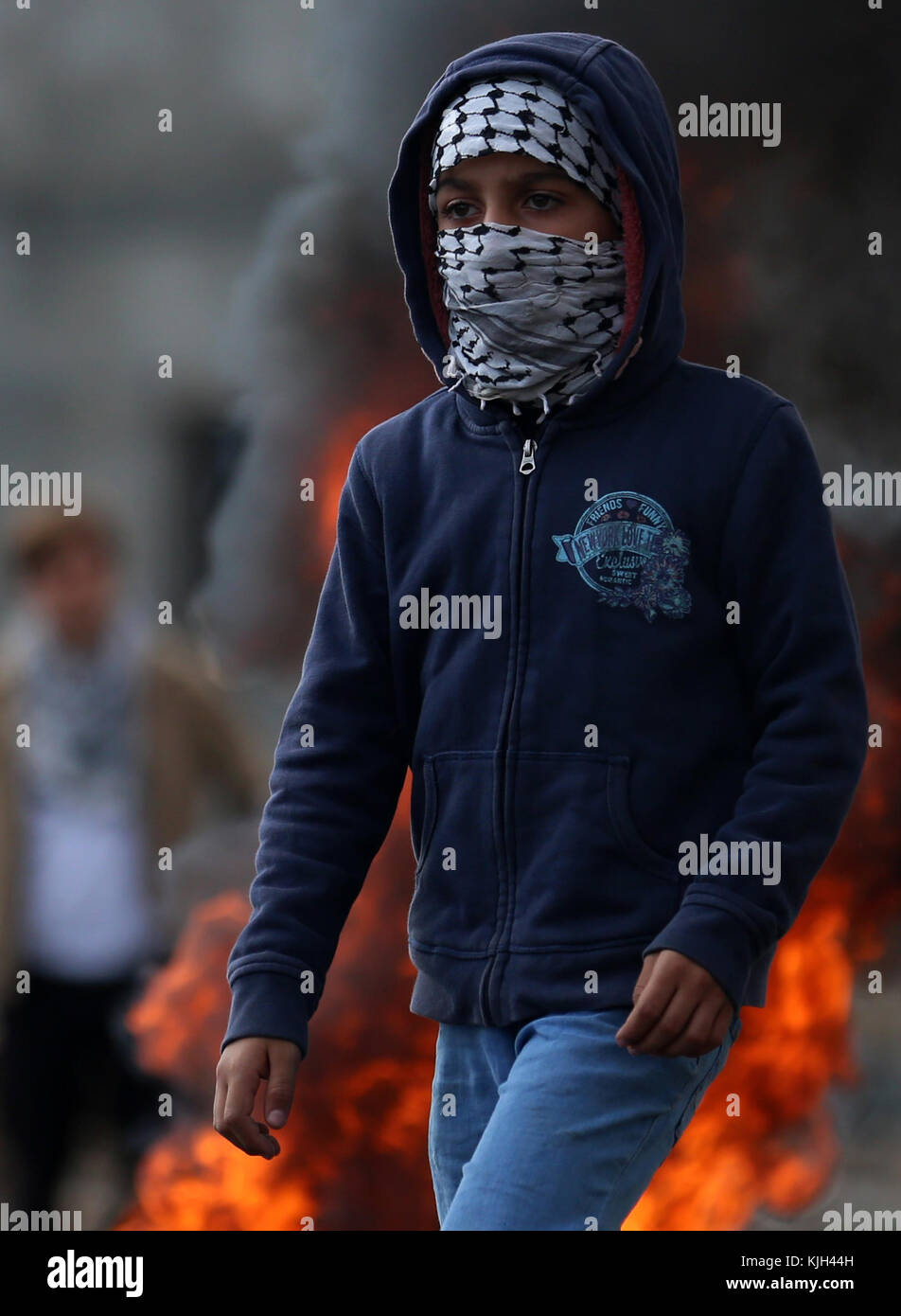 Nablus, West Bank, Palestinian Territory. 24th Nov, 2017. A Palestinian protester looks on during clashes with Israeli security forces following a weekly demonstration against the expropriation of Palestinian land by Israel in the village of Kfar Qaddum, near Nablus in the occupied West Bank, on November 24, 2017 Credit: Shadi Jarar'Ah/APA Images/ZUMA Wire/Alamy Live News Stock Photo