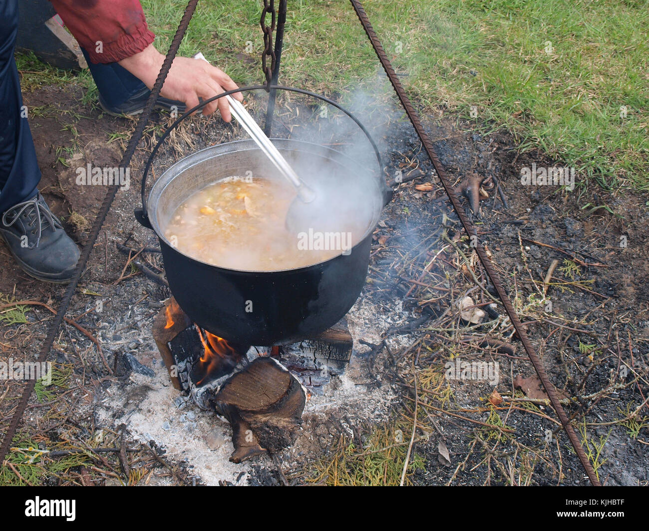 Cooking fish soup with salmon and vegetables in kettle on campfire Stock Photo Alamy