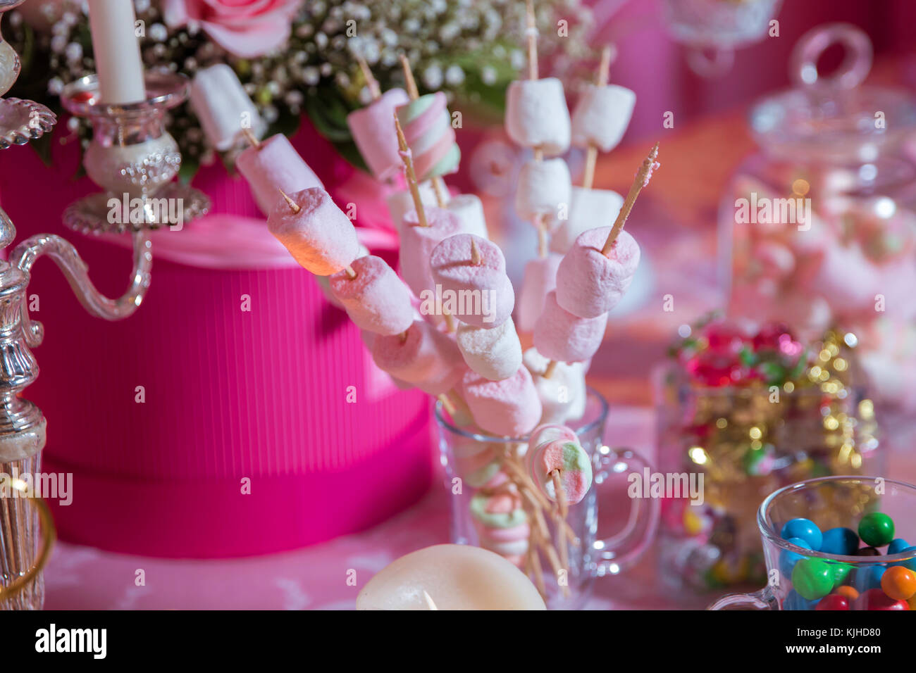 Candy Bar. Dessert table for a party. Marshmallow skewers Stock Photo