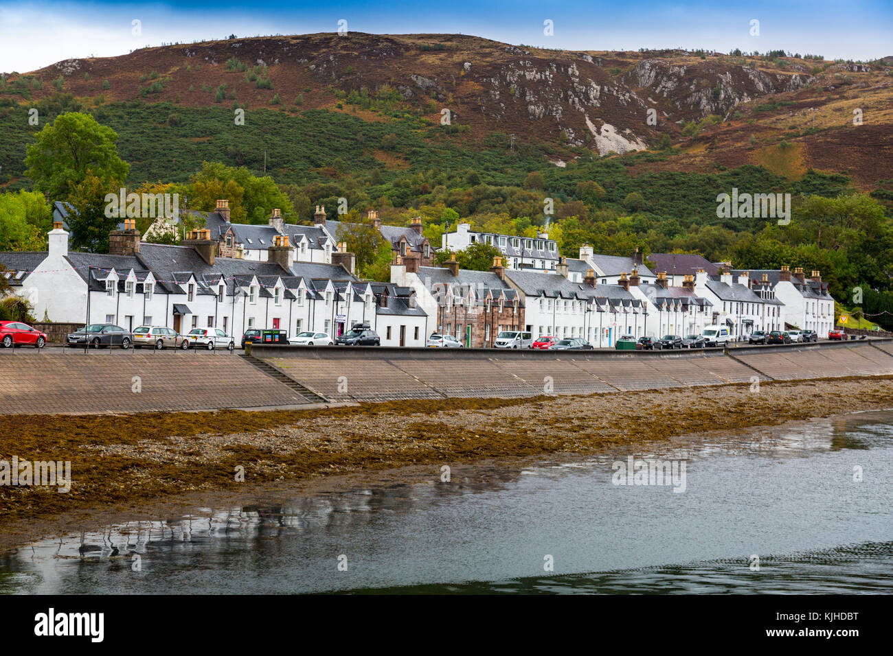 A terrace of waterfront houses and shops facing Loch Broom on Shore Street in Ullapool, Highland, Scotland, UK Stock Photo