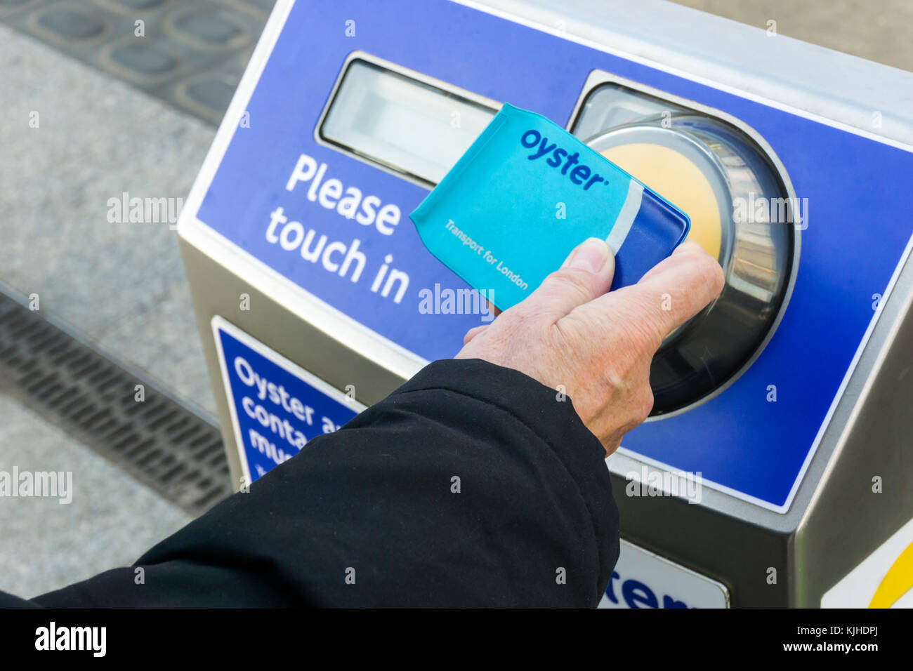 Passenger using a contactless Oyster card to pay the fare on London's