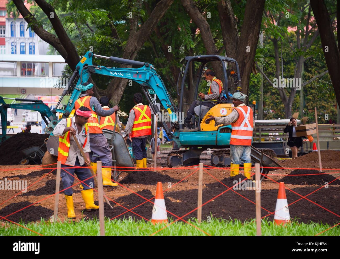 SINGAPORE - JAN 16, 2017: Workers work in public park in Singapore. Singapore is a major political, financial, cultural hub in Asia. Stock Photo