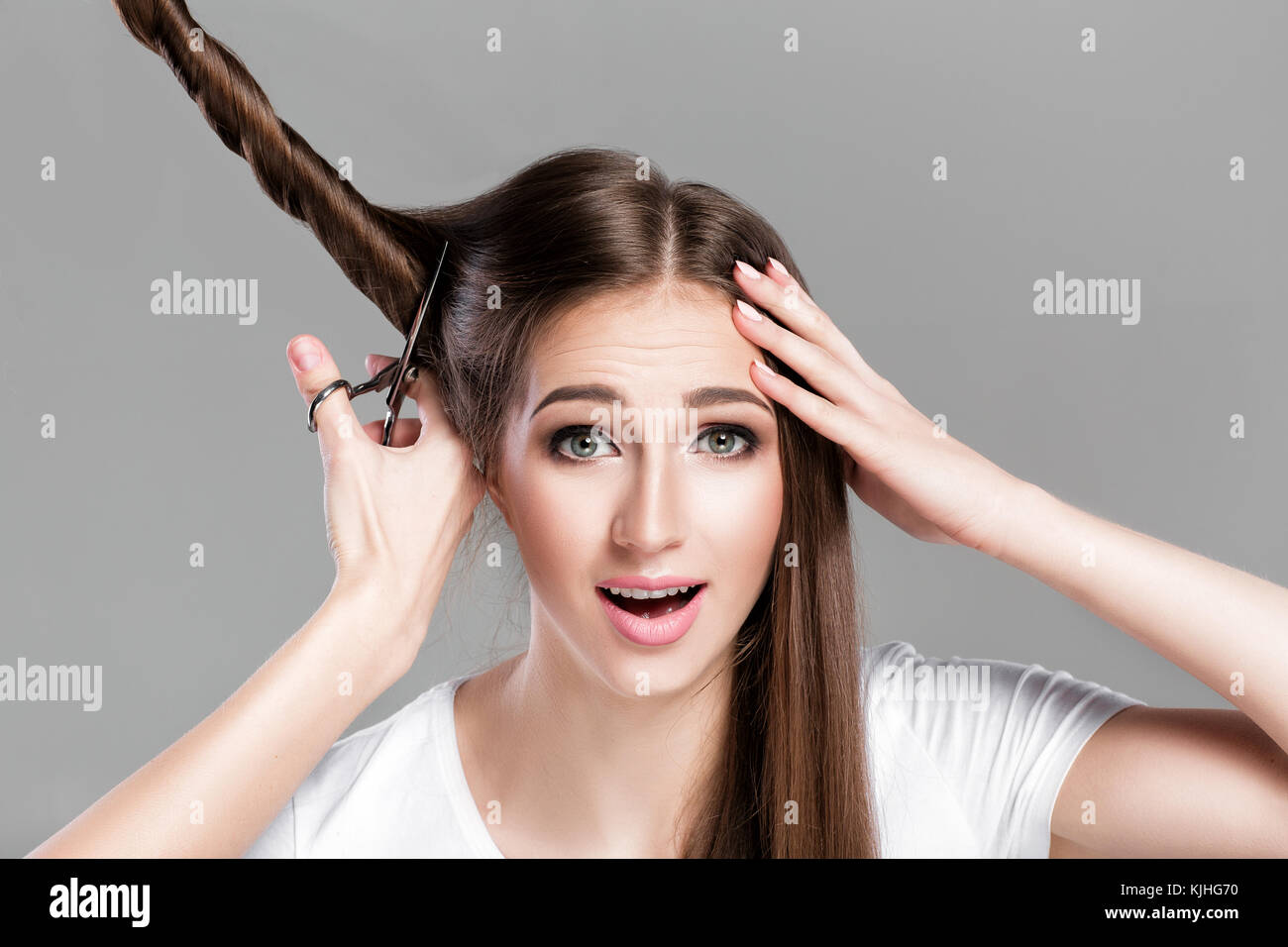 woman with  long hair holds scissors  Stock Photo