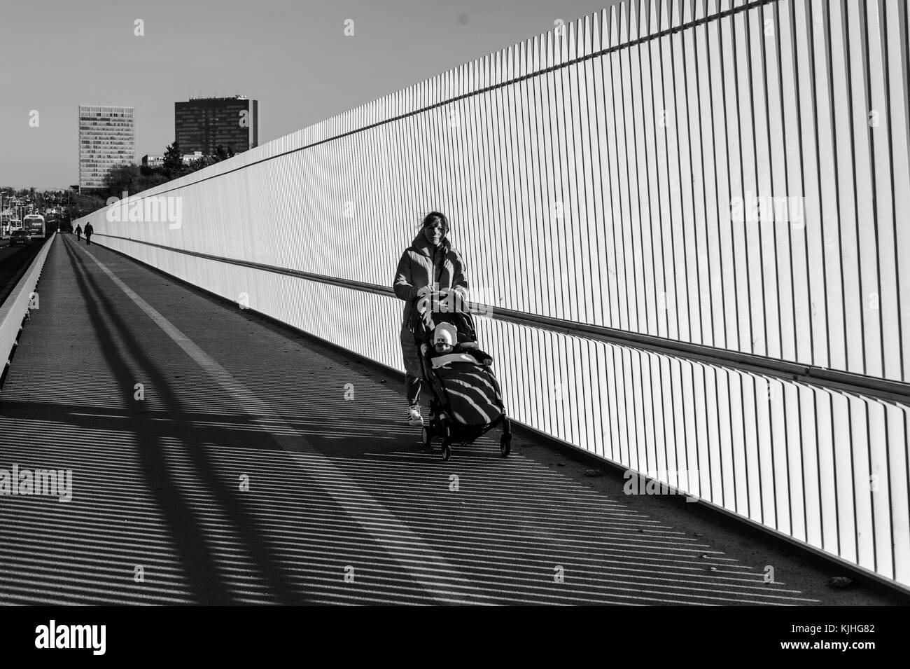 Young woman walking on the bridge with a stroller, black and white, Luxembourg City Stock Photo