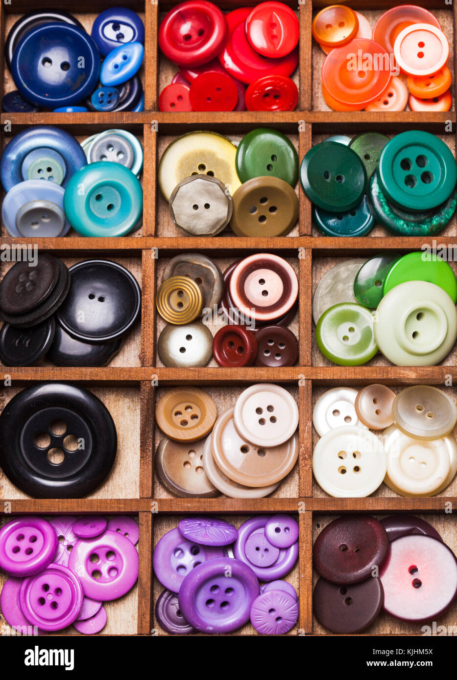 Colorful buttons in a wooden box for design Stock Photo - Alamy