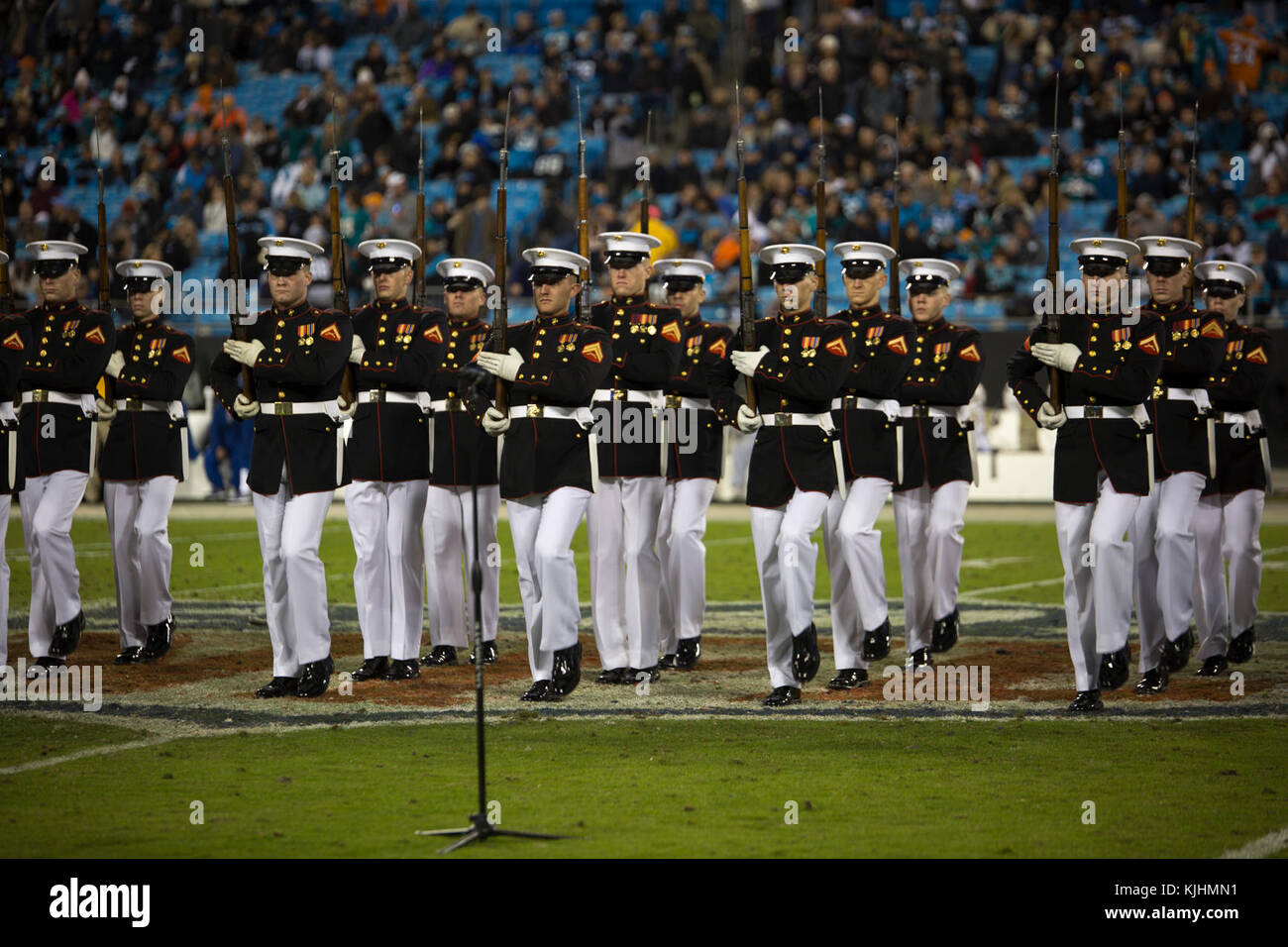 The U.S. Marine Corps Silent Drill Platoon performs precision marching and rifle drill movements during a Salute to Service halftime show at a Carolina Panthers vs. Miami Dolphins game at the Bank of America Stadium, Charlotte, N.C., Nov. 13, 2017. Throughout the year, SDP performs at numerous large-scale events across the country and abroad. (Official Marine Corps photo by Cpl. Damon Mclean/Released) Stock Photo