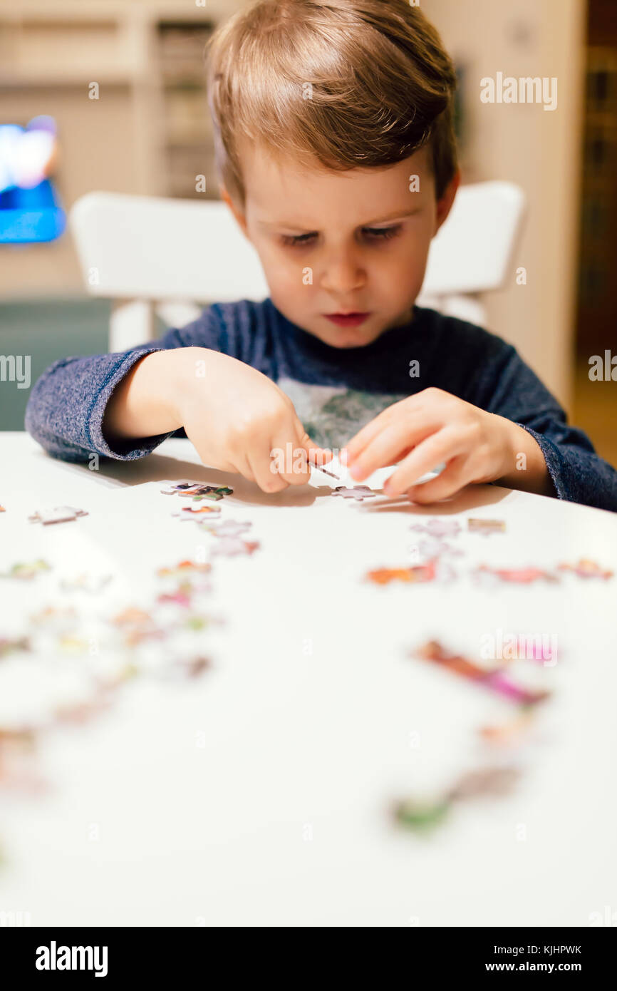 2 year old child solving jigsaw puzzle Stock Photo Alamy