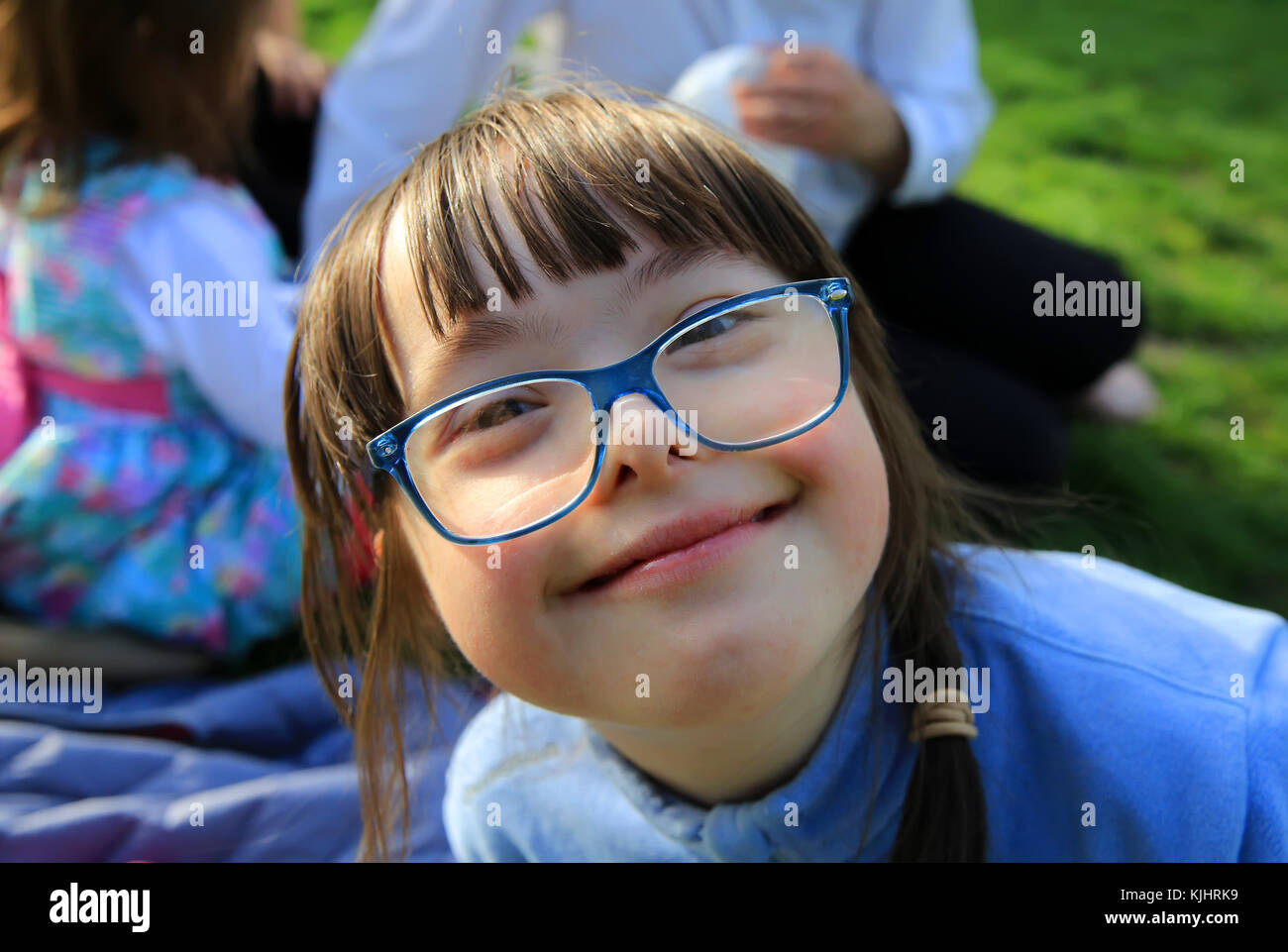 Portrait of little girl smiling outside Stock Photo - Alamy