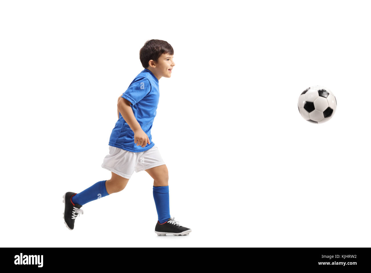 Full length profile shot of a little footballer running isolated on white background Stock Photo