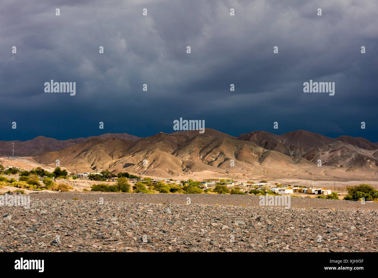 Storm over a town in the Altiplano, Chile Stock Photo
