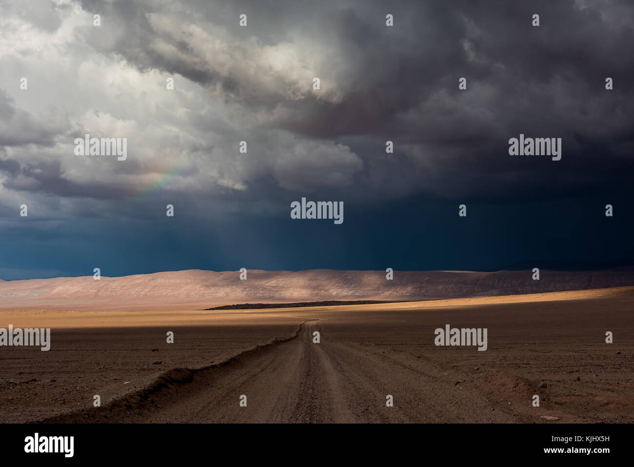 Rainbow and storm over the Atacama desert, Chile Stock Photo