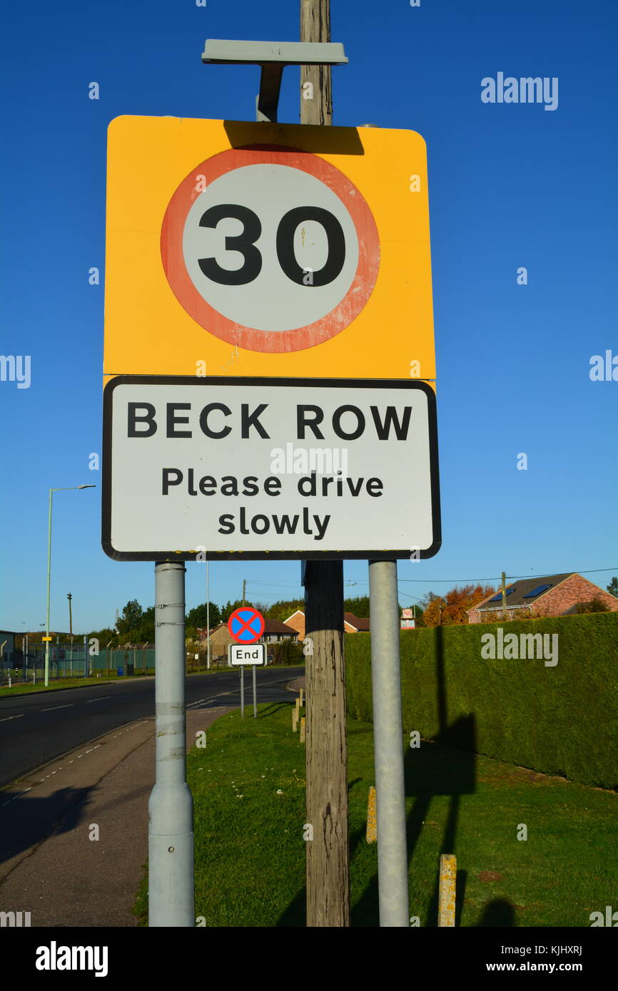 British  30 mph road sign with village name Beck Row. Mildenhall airbase village in the background. Stock Photo