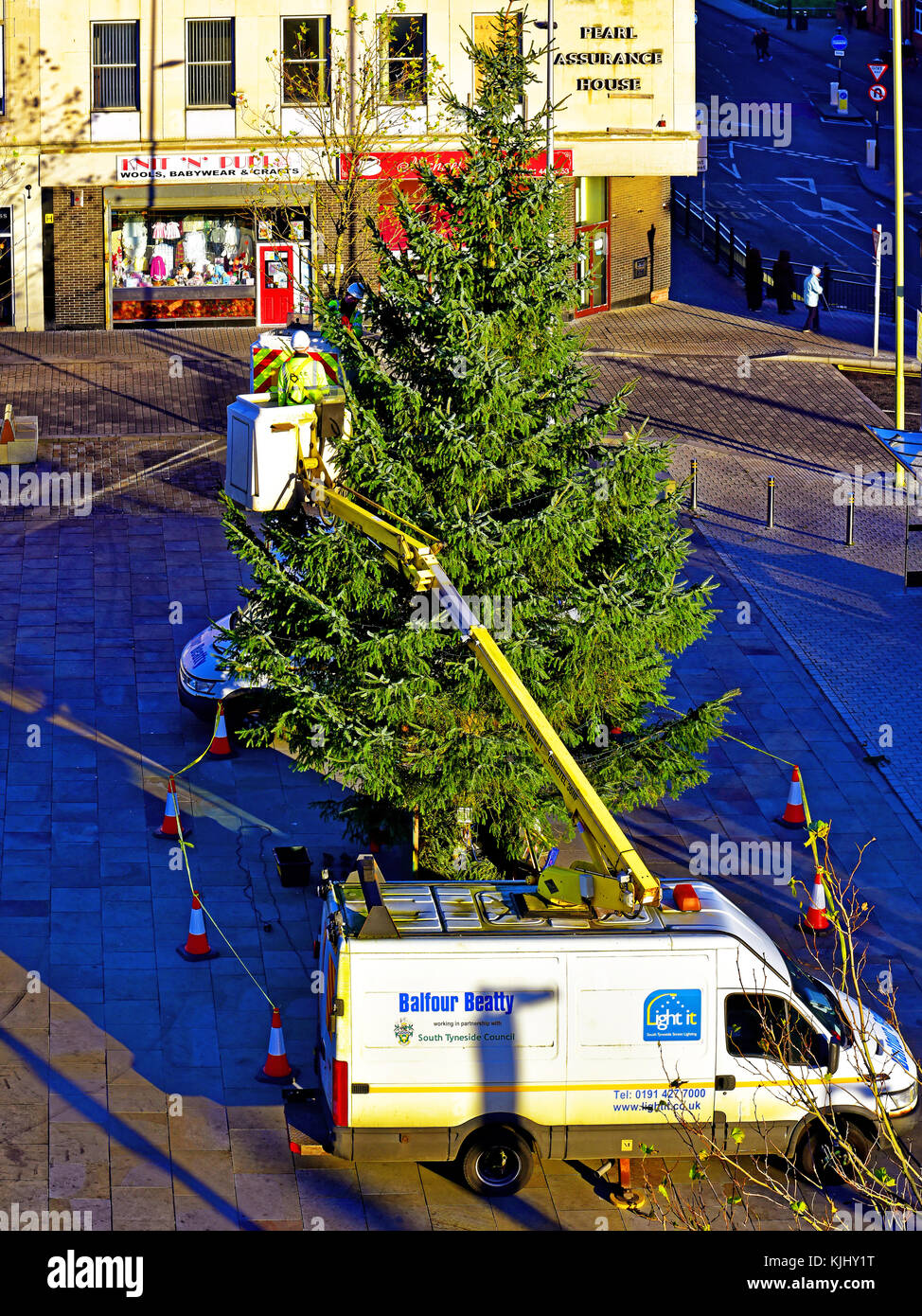 South Tyneside Council workers putting up the Xmas tree in South Shields Market Square Stock Photo