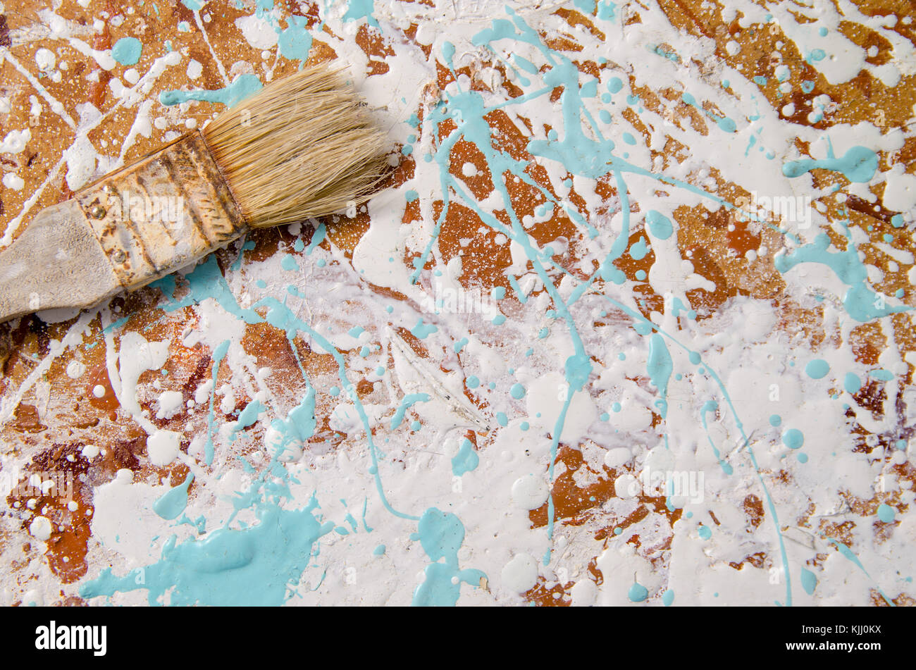 a brush on a hardboard stained with paint background Stock Photo