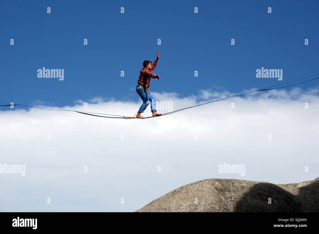 An unidentified adventurer climber tries some rope walking among the limestone outcrops at Castle Hill, South Island, New Zealand Stock Photo