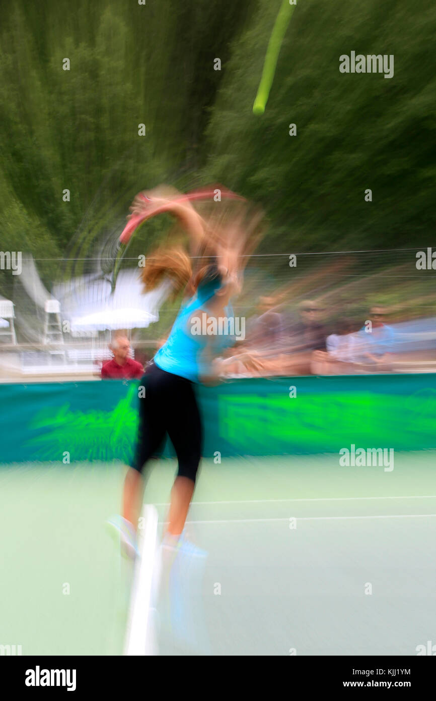 Tennis player hitting ball on a court.  France. Stock Photo