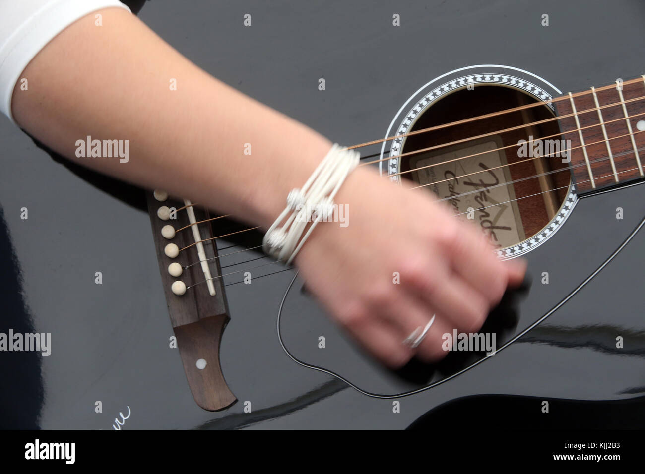 Young woman playing guitar. Close-up.  France. Stock Photo
