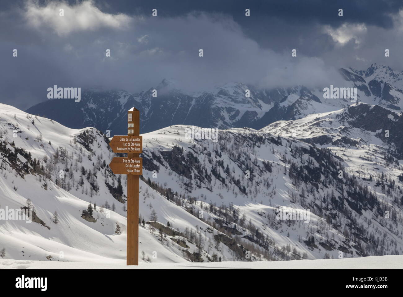 Footpath sign on the Col de la Lombarde or Colle della Lombarda, on the French-Italian border in spring; looking north. Maritime Alps. Stock Photo