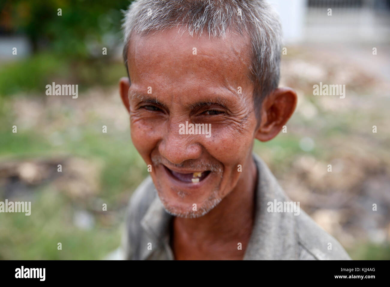 Disabled man living on the fringe of a slum. Battambang.  Cambodia. Stock Photo