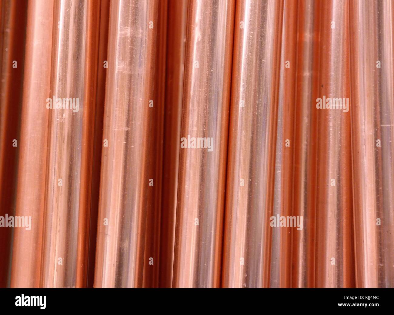 Close-up of red copper metal. Industrial round steel tubes. Pipes for conducting electricity and heat. Stock Photo
