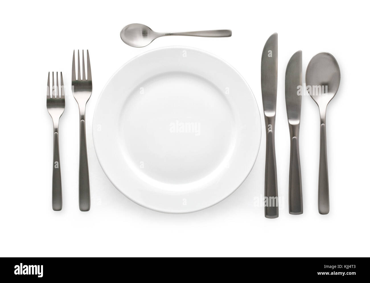 Place setting with plate, knife and fork. on white background Stock