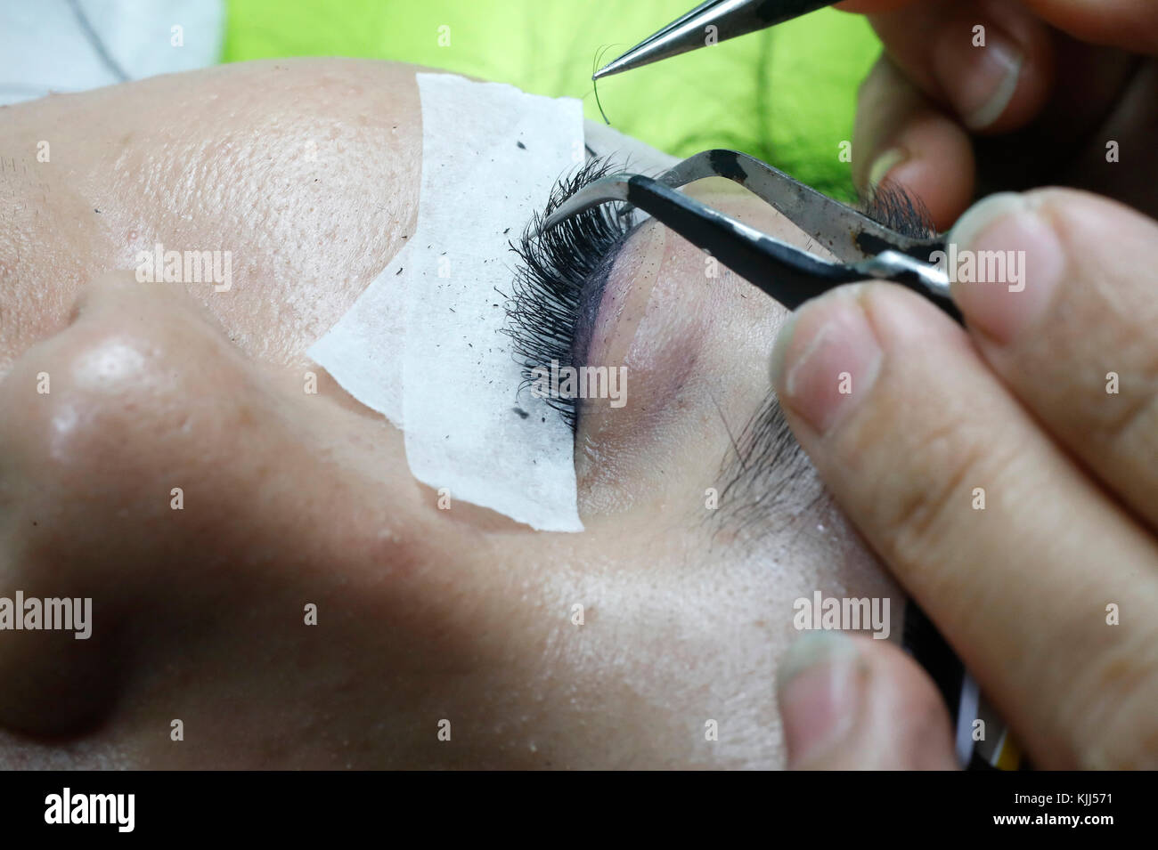 Vietnamese beauty salon. Beautician applying extended eyelashes to woman.  Ho Chi Minh City. Vietnam. Stock Photo