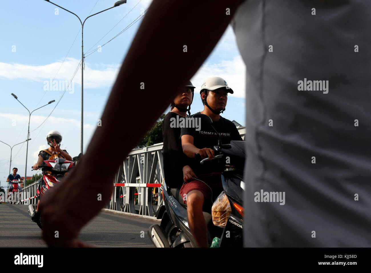 Vietnamese People on Motorbikes. Road traffic.  Ho Chi Minh City. Vietnam. Stock Photo