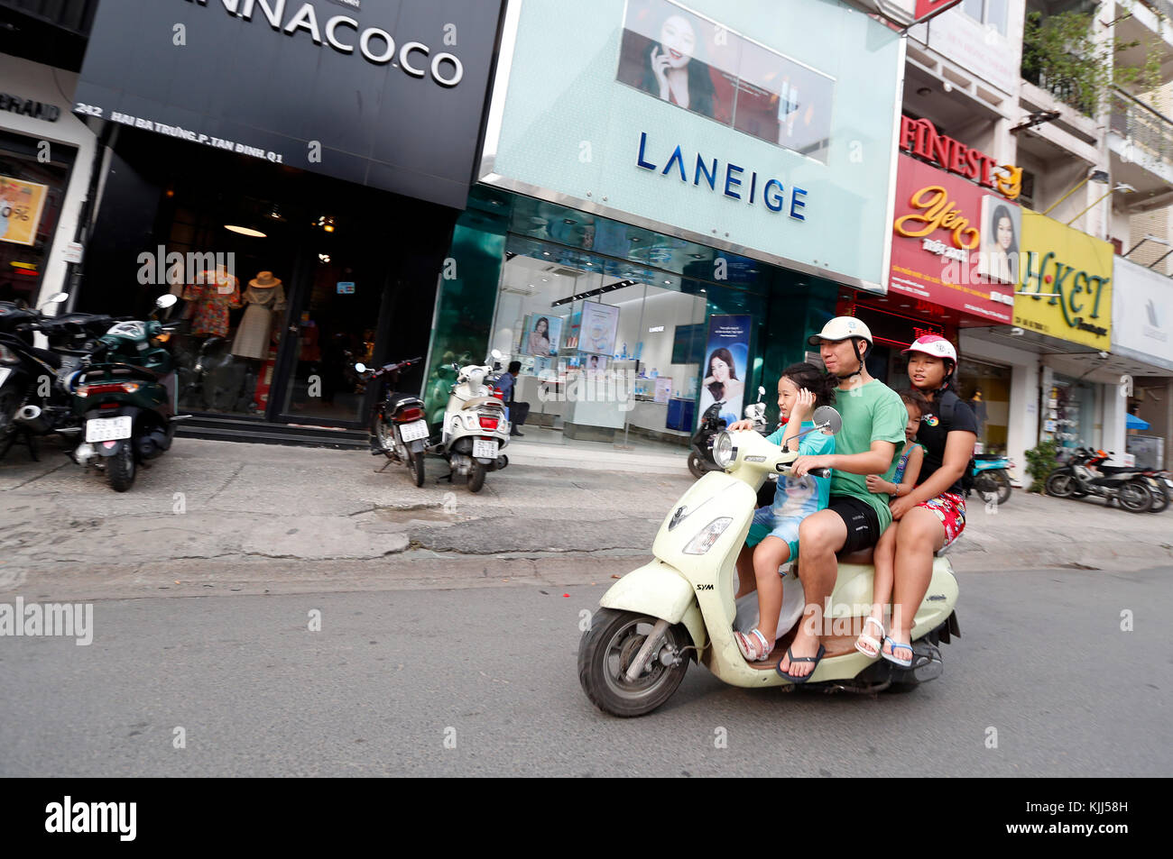 Vietnamese family on a scooter. Ho Chi Minh City. Vietnam. Stock Photo