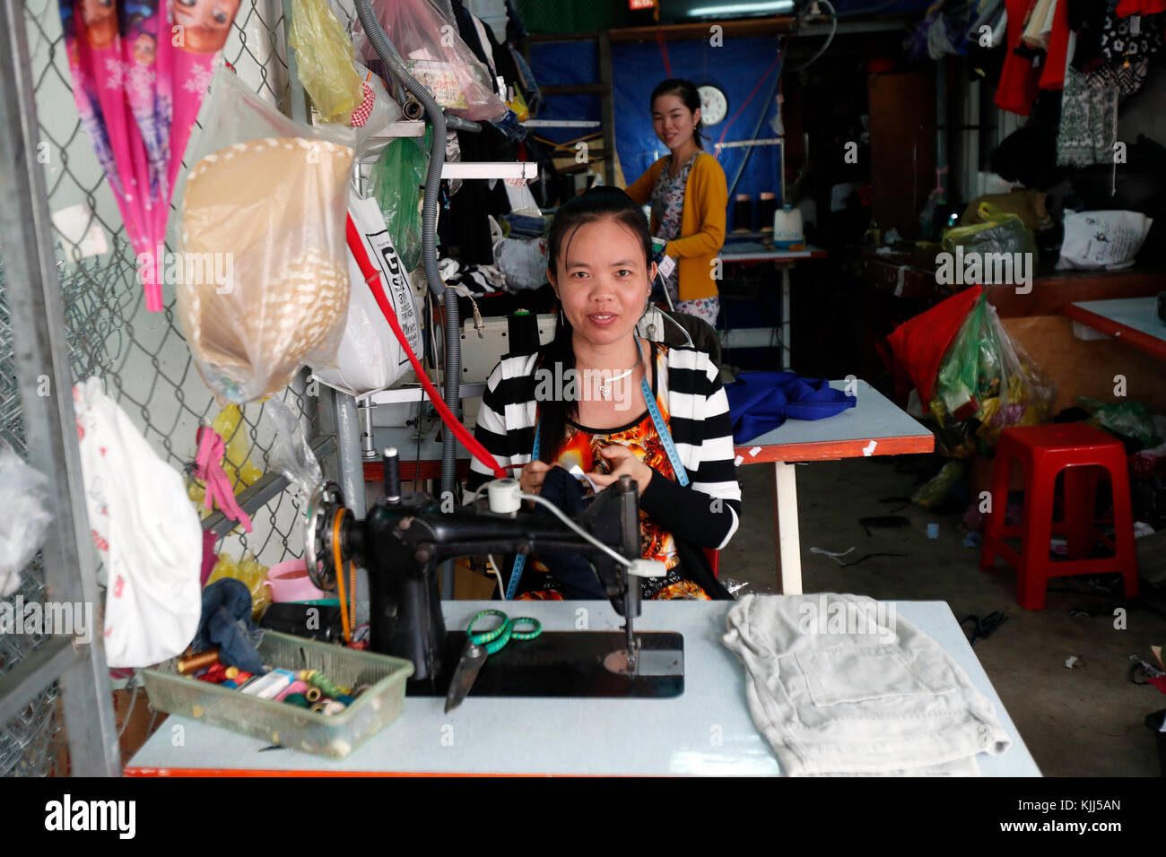 Vietnamese woman working at sewing machine. Kon Tum. Vietnam. Stock Photo