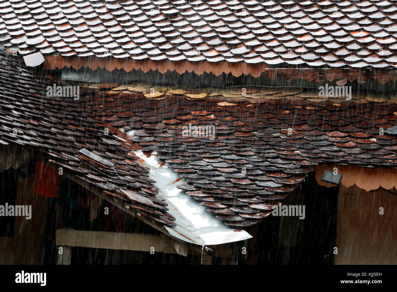 Bahnar (Ba Na) ethnic group traditional house under heavy monsoon rain. Kon Tum. Vietnam. Stock Photo