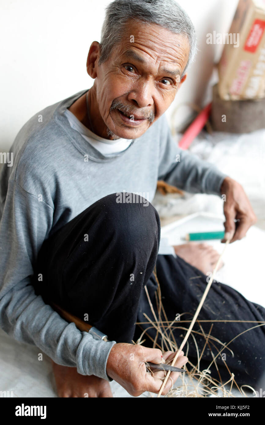 Bahnar (Ba Na) ethnic group.  Old man using draw on wood.  Kon Tum. Vietnam. Stock Photo