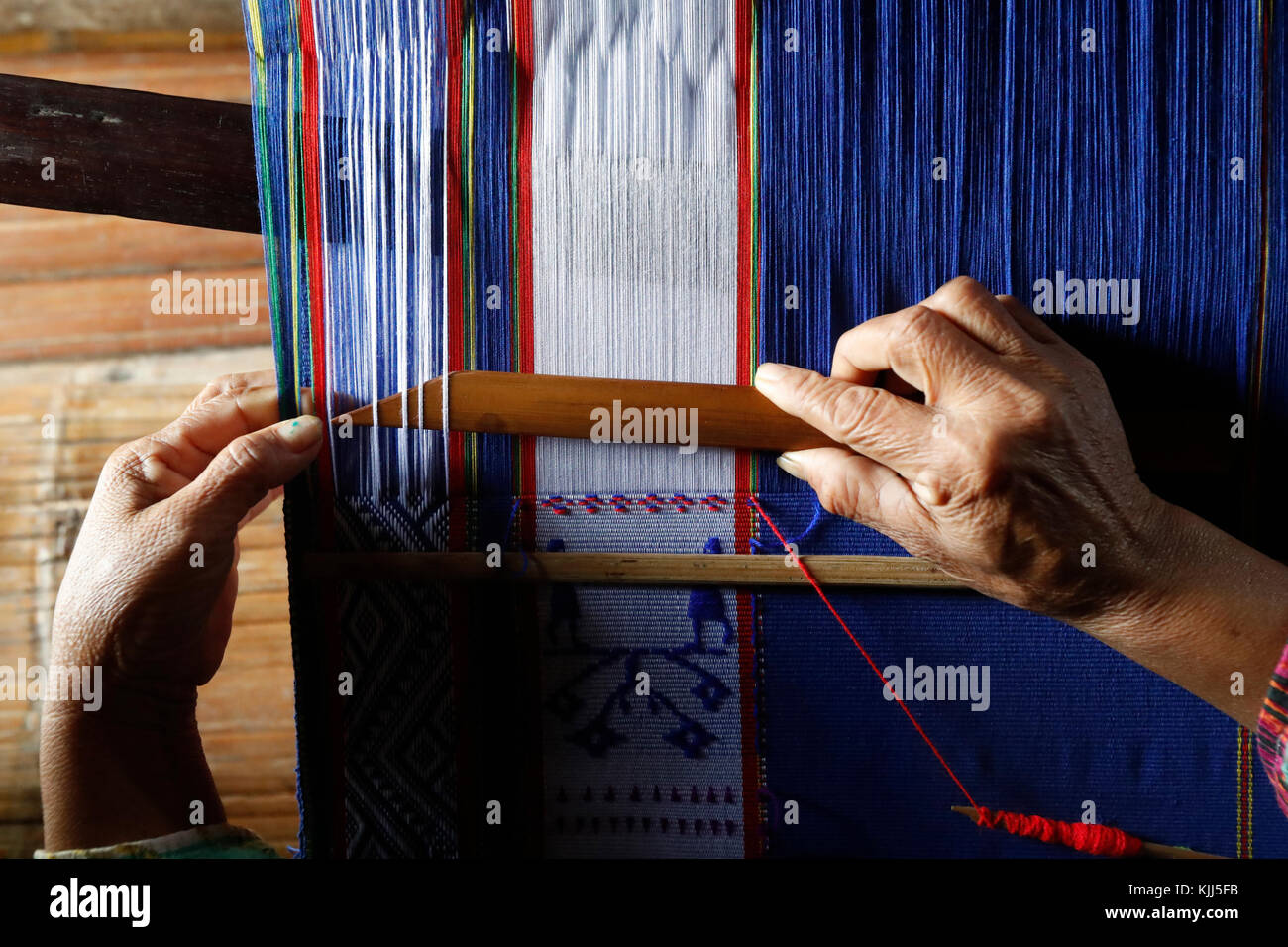 Bahnar (Ba Na) ethnic group.  Woman weaving silk at wooden loom.  Kon Tum. Vietnam. Stock Photo