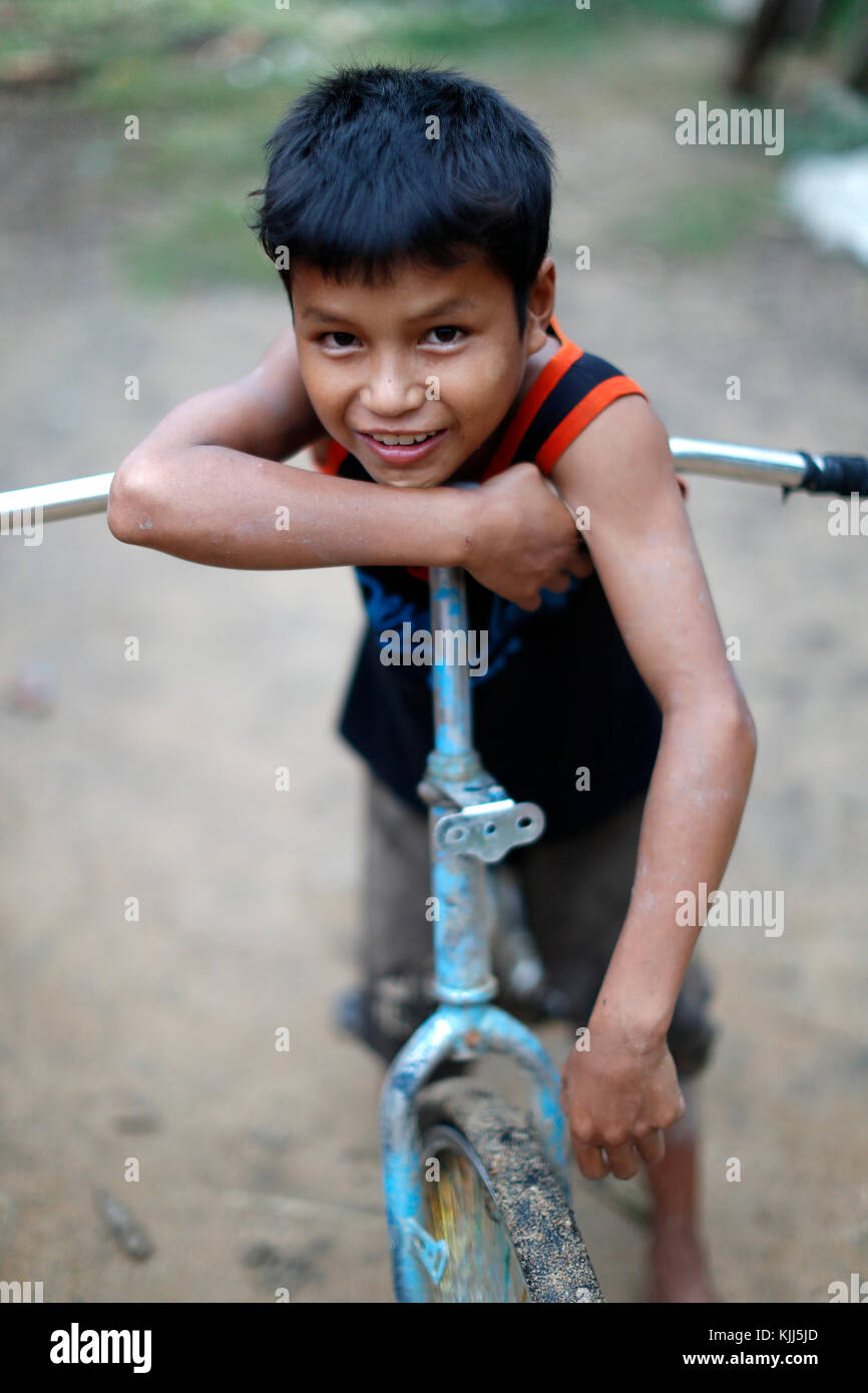 Bahnar (Ba Na) ethnic group.  Young boy with bicycle. Portrait.  Kon Tum. Vietnam. Stock Photo