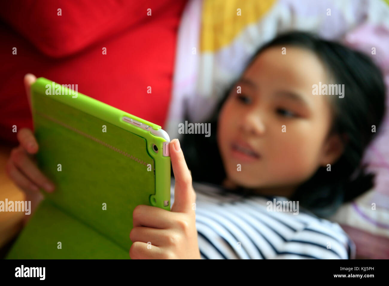 Girl playing with her tablet  Vietnam. Stock Photo