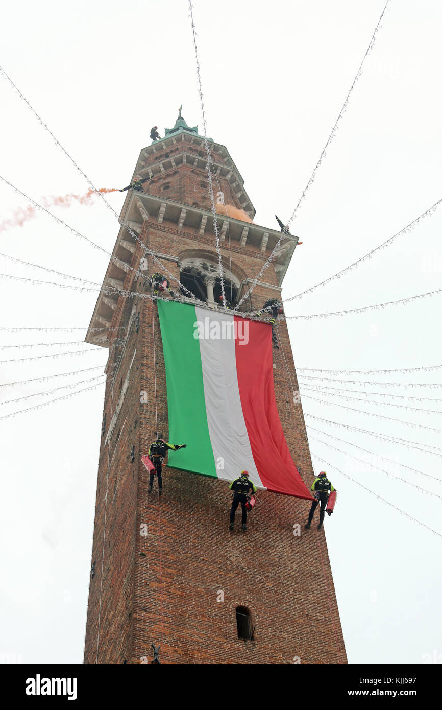 Vicenza, VI, Italy - December 4, 2015: Firefighters with a big italian flag and the tower of ancient Palace called Basilica Palladiana during an exerc Stock Photo
