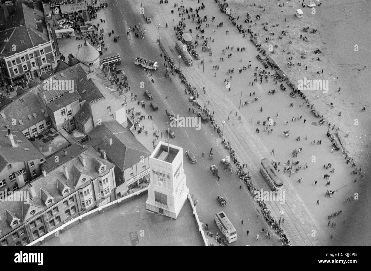 1940s view from the top of the Blackpool Tower in England.Blackpool Tower is a tourist attraction in Blackpool, Lancashire, England, which was opened to the public on 14 May 1894. Inspired by the Eiffel Tower in Paris, it is 518 feet (158 metres) tall and is the 120th tallest freestanding tower in the world. Blackpool Tower is also the common name for Tower buildings, an entertainment complex in a red-brick three-storey block comprising the tower, the ground floor aquarium and cafeteria, Tower Circus, the Tower Ballroom and roof gardens that was designated a Grade I listed building in 1973. Stock Photo