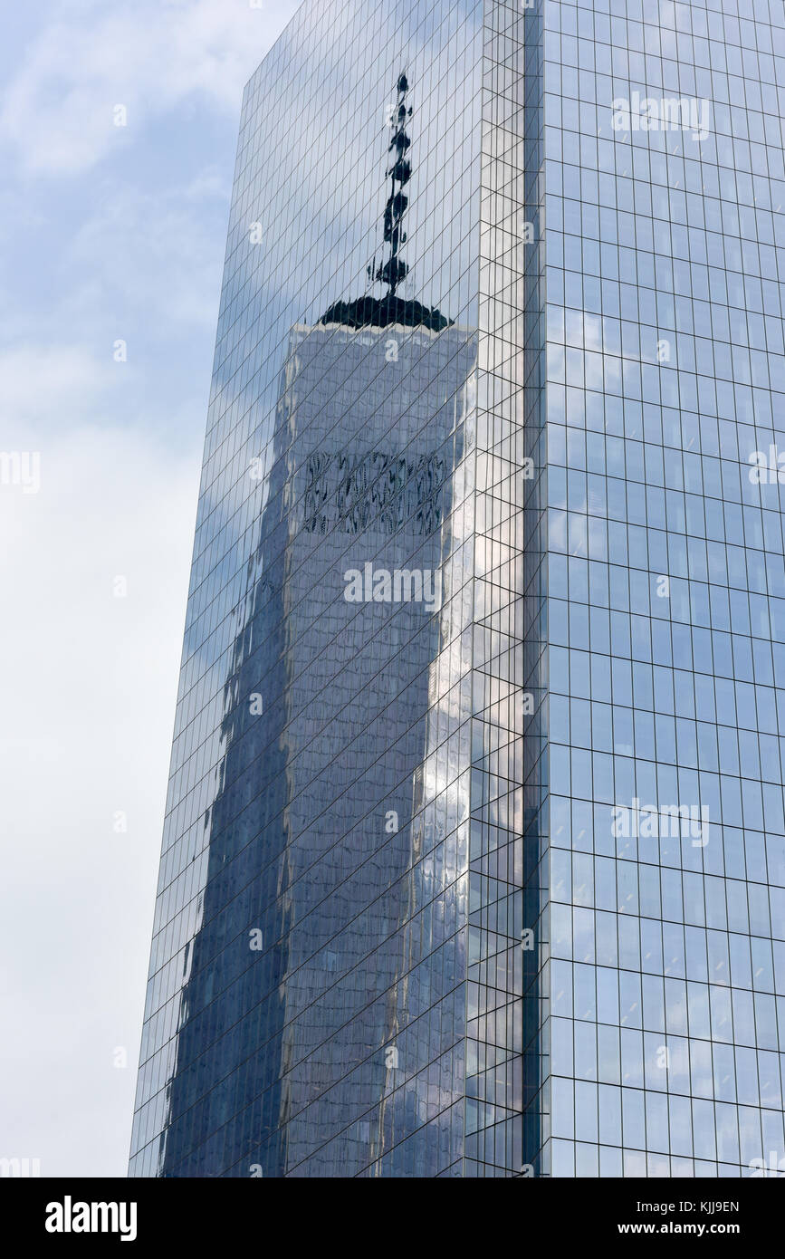 New York, NY - April 5, 2015: One World Trade reflecting off of Four World Trade Center in lower Manhattan. Stock Photo
