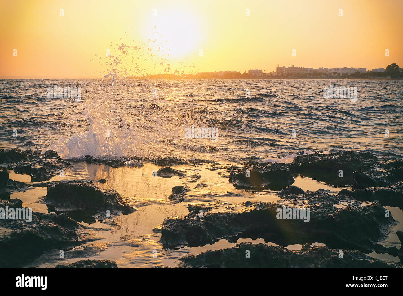 Rocky coast of the sea with splashing waves Stock Photo - Alamy