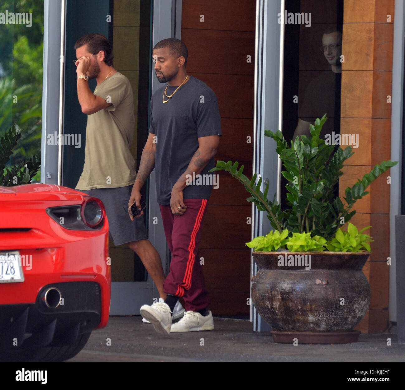 MIAMI BEACH, FL - SEPTEMBER 15: Scott Disick and Singer Kanye West leave  their Miami hotel doing their version of Miami Vice. They looked like  Crockett and Tubbs as the duo jumped