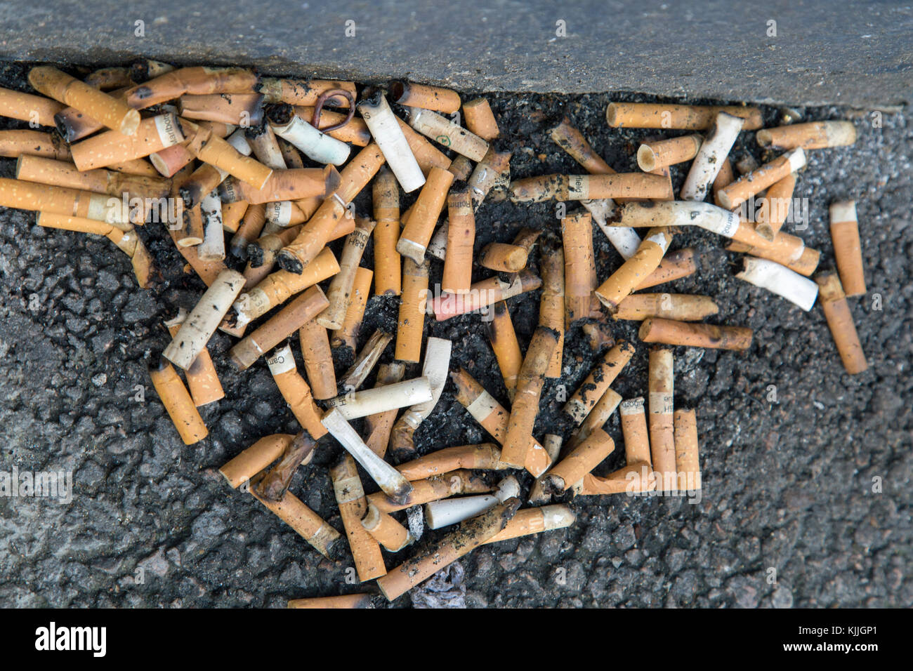 London, England, November 2017, a pile of cigarette ends on the floor Stock Photo