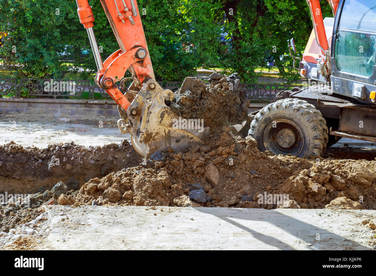 excavator at sandpit during earthmoving works digs the road Stock Photo ...
