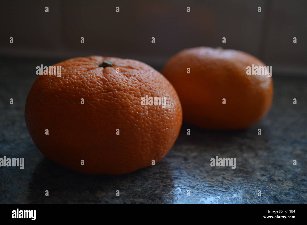 Pair of satsumas on kitchen worktop Stock Photo Alamy
