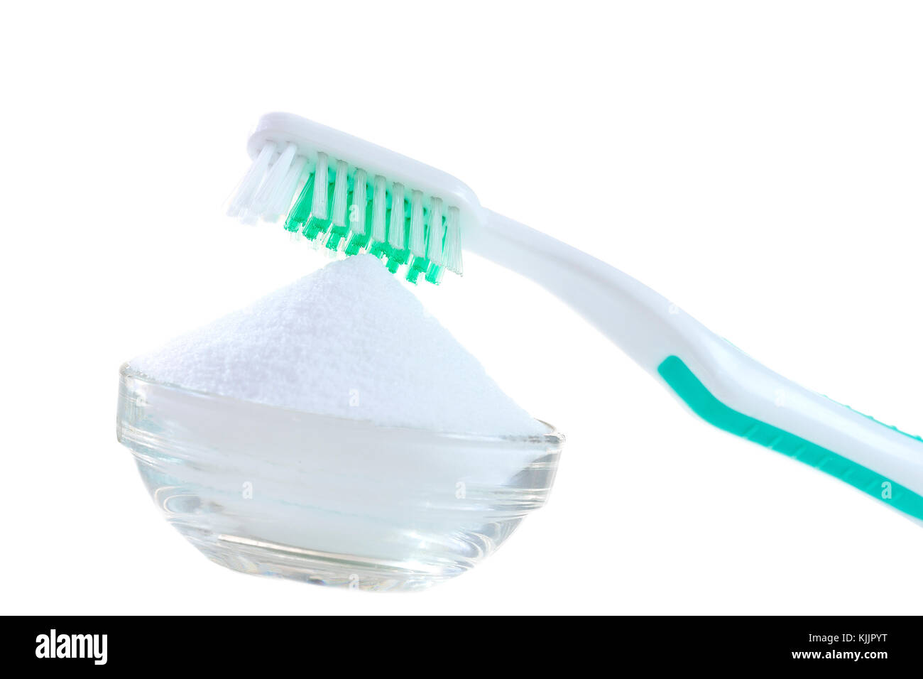 Top view of baking soda bowl with tooth brush on white Stock Photo