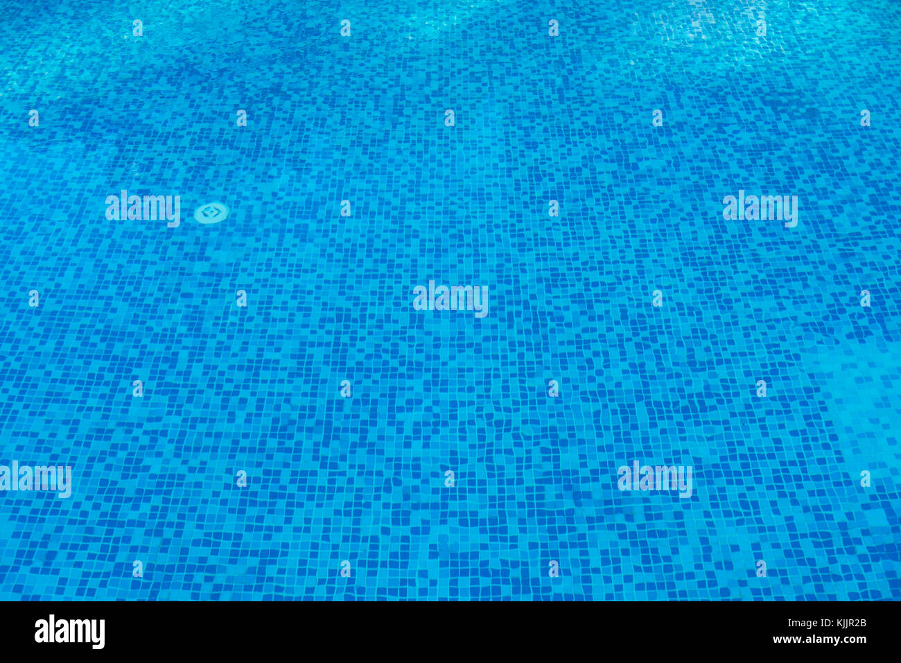Blue abstract mosaic tiles at the bottom of the swimming pool ...