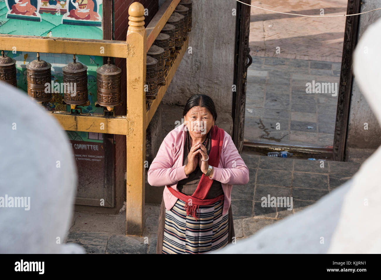 Tibetan woman praying, Boudhanath, Kathmandu, Nepal Stock Photo