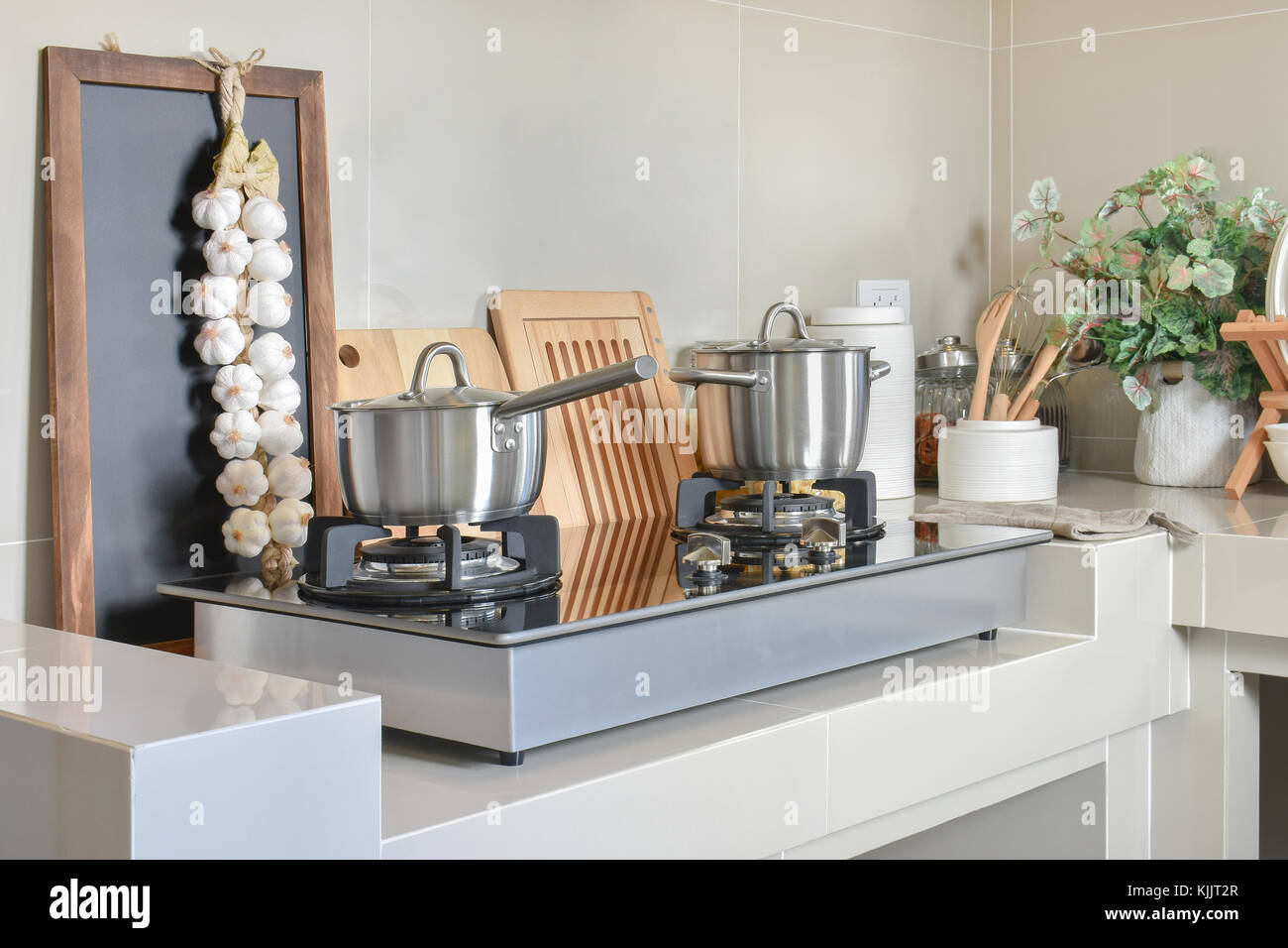 stainless pan on gas stove with utensil in modern kitchen Stock Photo