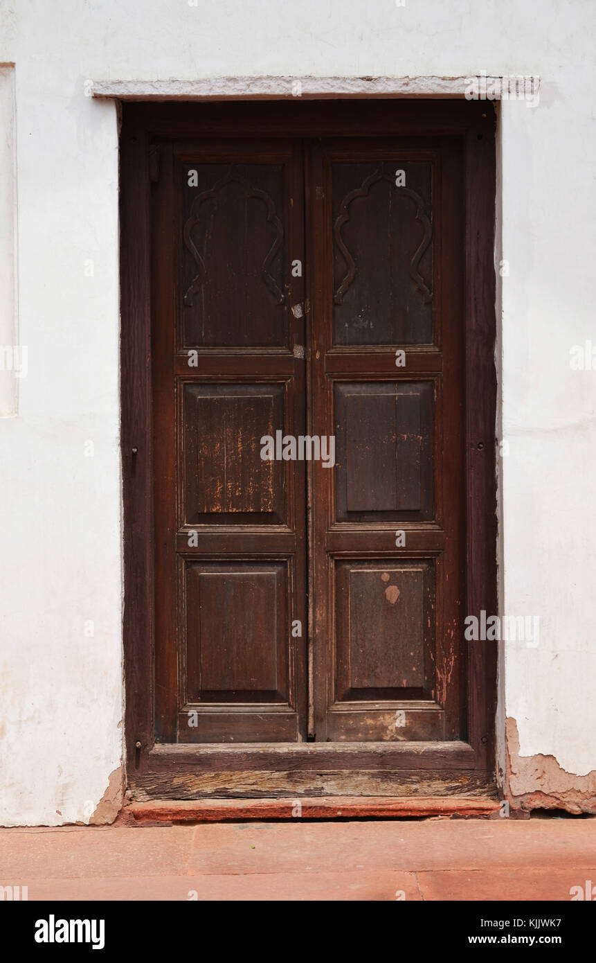 Old dark wooden door in stone doorway taken in New Delhi India Stock Photo