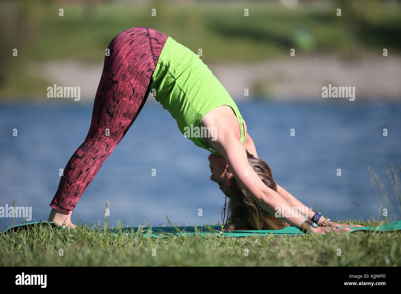 Woman doing yoga and meditation outside. Stock Photo